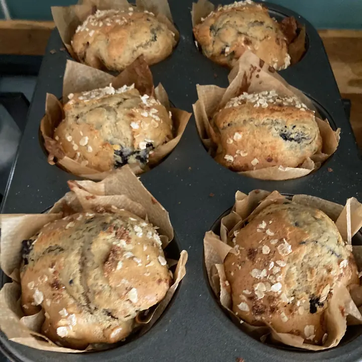Blueberry muffins with oat crumble tops in paper cases