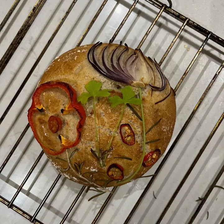 Focaccia decorated with a garden of vegetable flowers