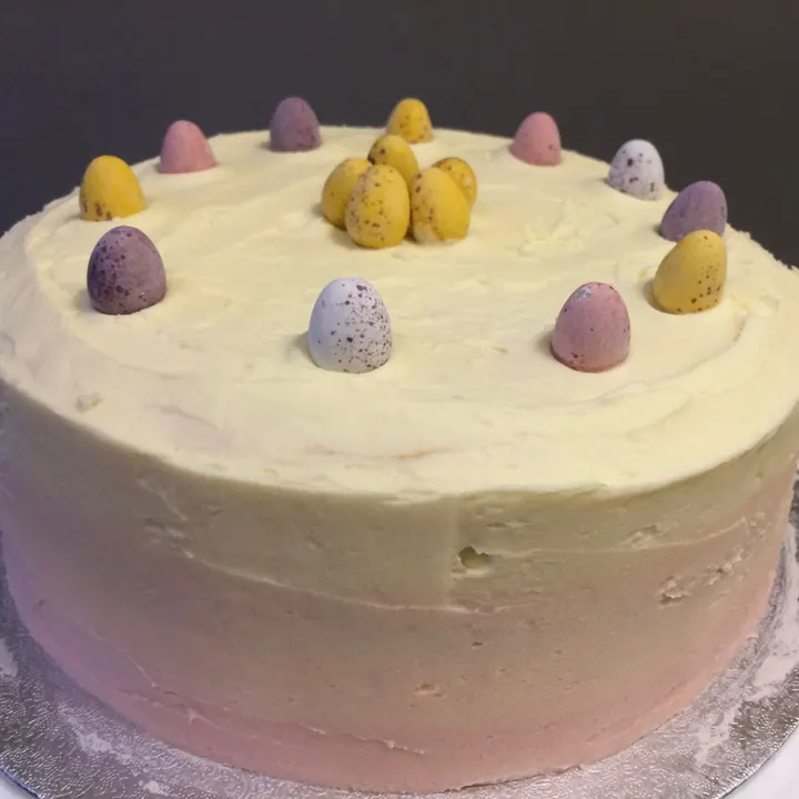 Pink and white ombre Easter cake decorated with mini eggs
