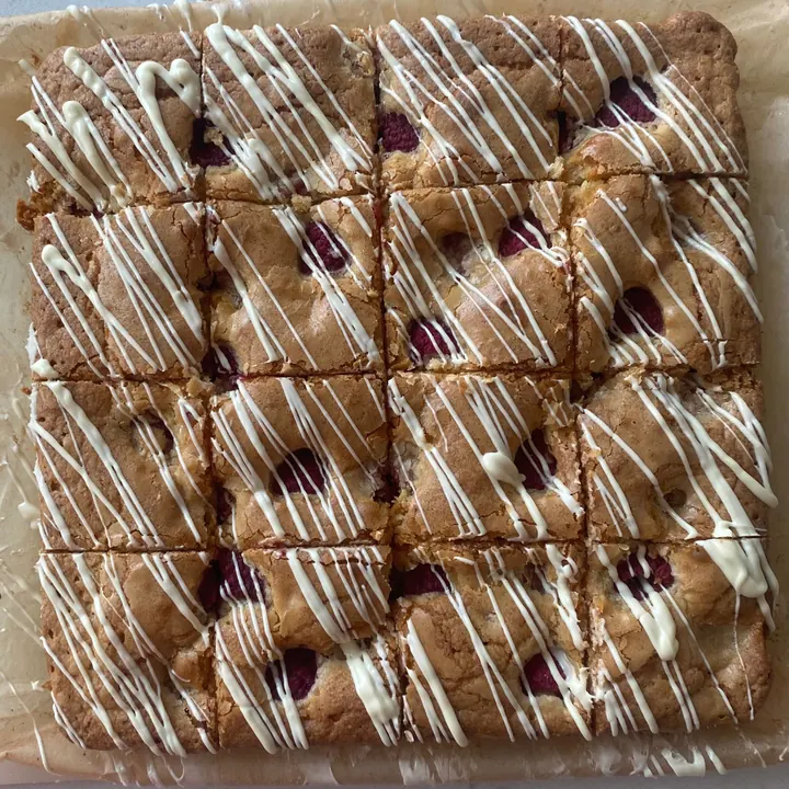 Raspberry and white chocolate blondies with a white chocolate drizzle