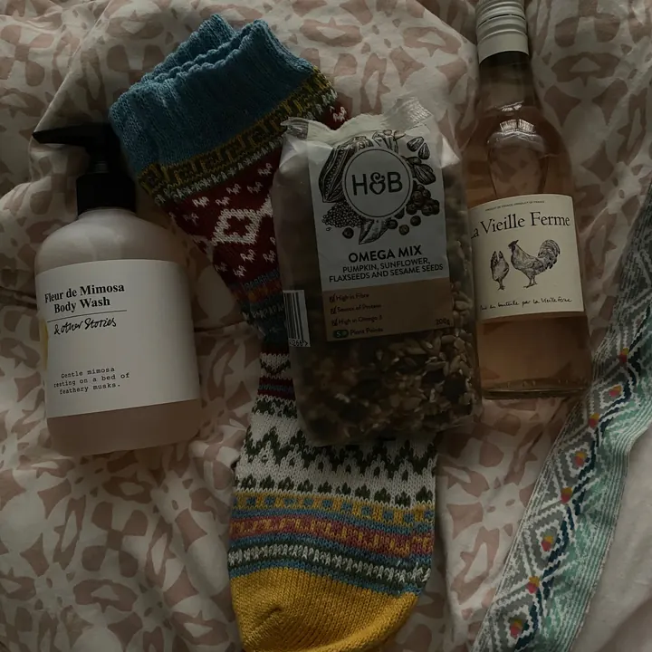 Christmas stocking gifts laid out on a bed