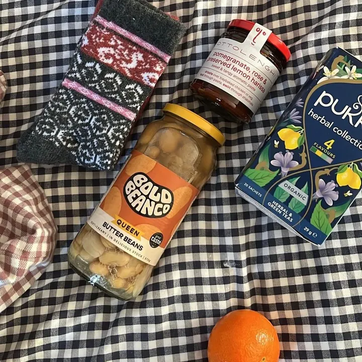 Christmas stocking gifts laid out on a gingham cloth