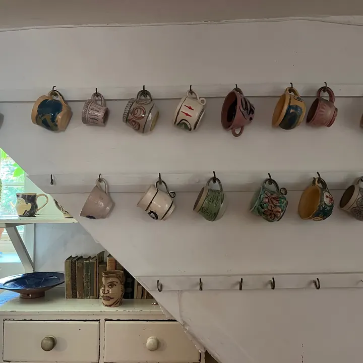 Rows of hanging mugs in the kitchen at Charleston