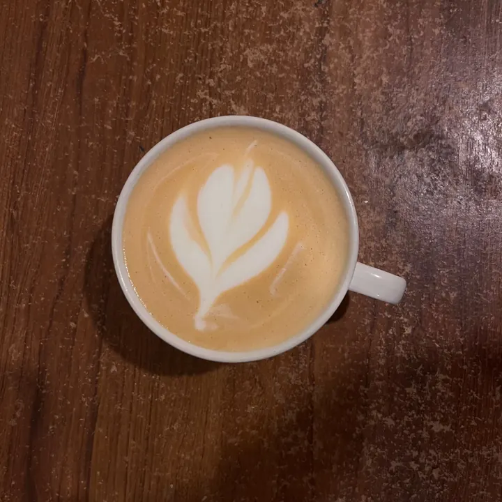 Rooibos latte on a dark wooden table