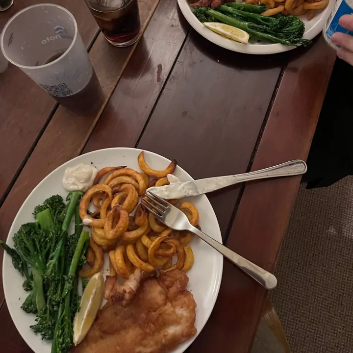 Homemade fish with curly fries and broccoli